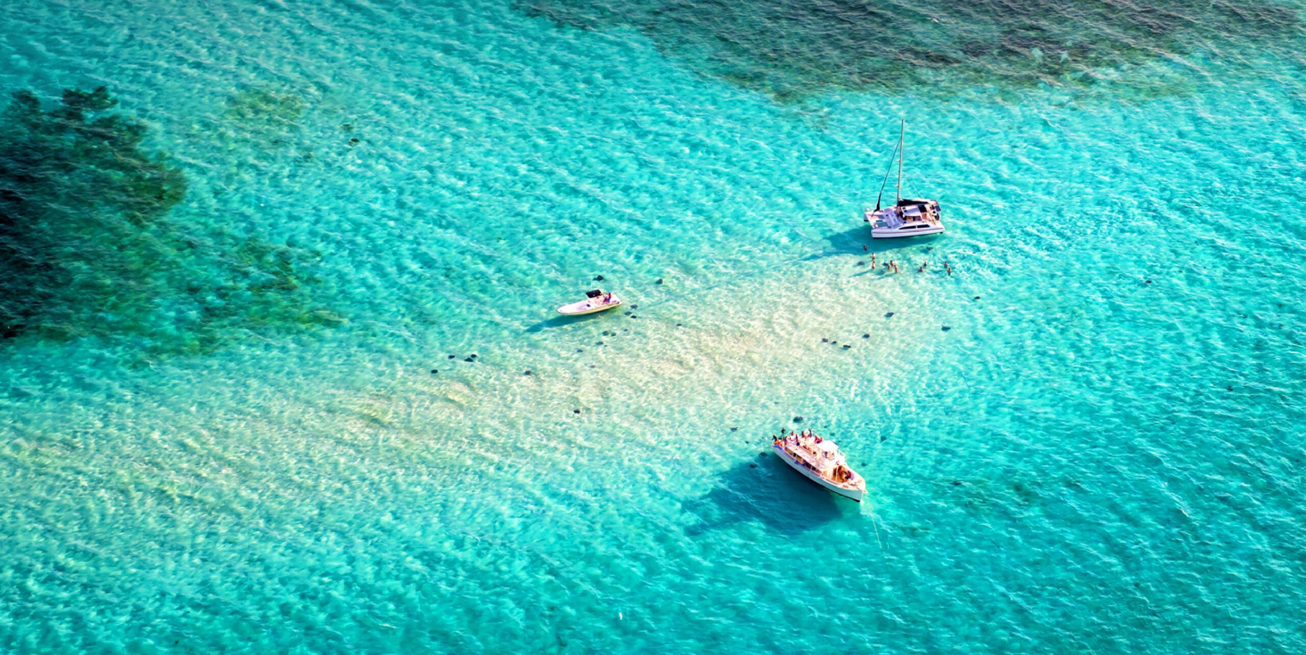 three boats in the ocean