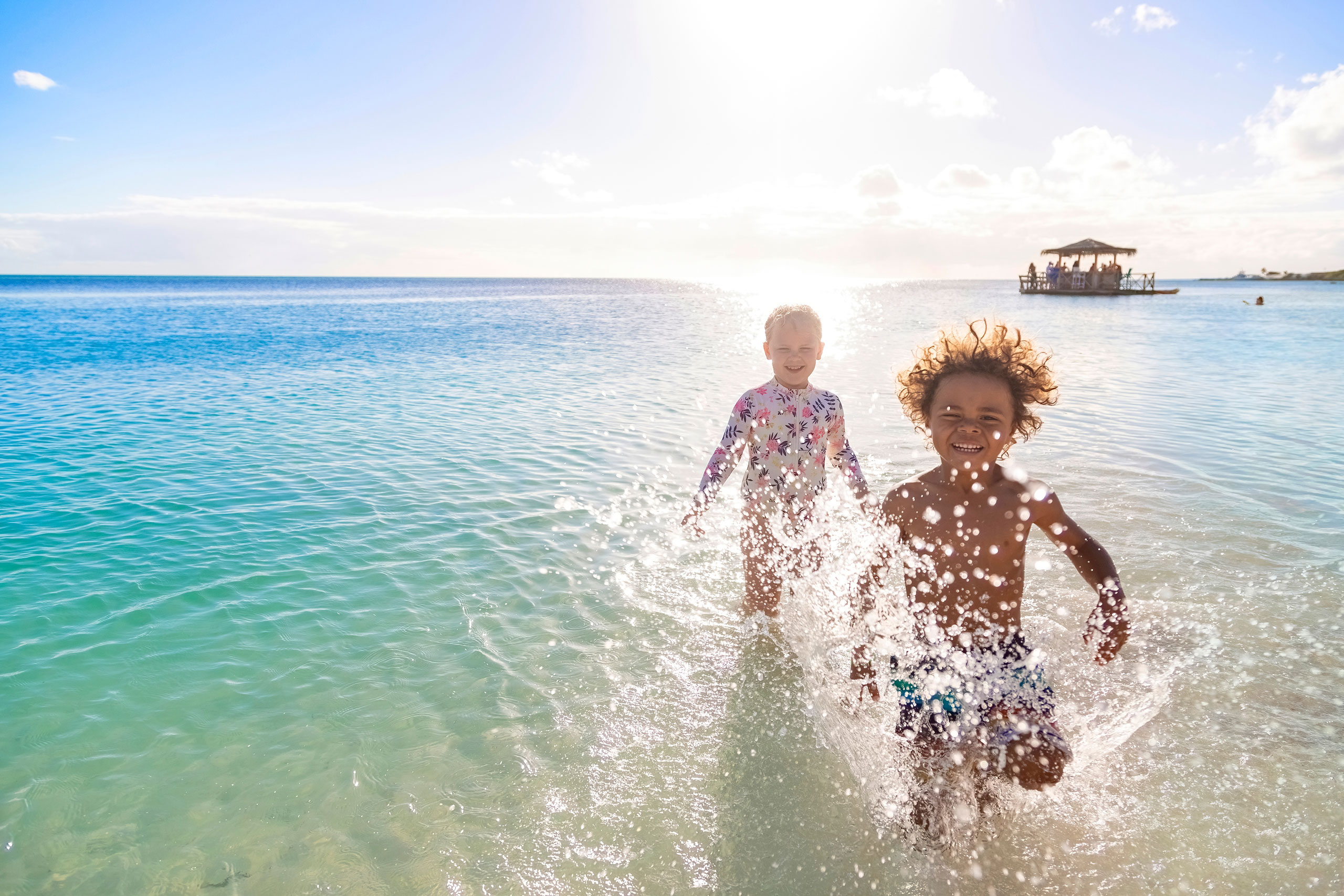 Children splashing in water at the beach